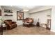 Cozy living room area featuring a piano, leather chair, wall art, and decorative shelving at 5641 E Aster Dr, Scottsdale, AZ 85254