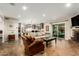 Bright living room flowing into kitchen with stainless steel appliances and large island at 5641 E Aster Dr, Scottsdale, AZ 85254