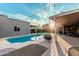 Beautiful backyard with a sparkling pool, lush landscaping, and a covered patio for outdoor entertaining and relaxation at 5641 E Aster Dr, Scottsdale, AZ 85254