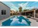 Backyard pool and covered patio is perfect for outdoor entertaining in this beautifully landscaped home at 5641 E Aster Dr, Scottsdale, AZ 85254