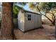 A sturdy outdoor shed with a window offers additional storage space in the backyard at 5641 E Aster Dr, Scottsdale, AZ 85254