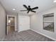 Bedroom displaying carpet floors, modern ceiling fan, closet, and natural light at 6254 E Winchcomb Dr, Scottsdale, AZ 85254