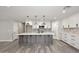 Modern kitchen with a gray island, white cabinets, and decorative backsplash at 6254 E Winchcomb Dr, Scottsdale, AZ 85254