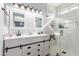 A modern bathroom features double sinks, white cabinetry, and a glass-enclosed shower at 6399 S Twilight Way, Gilbert, AZ 85298