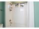 This bathroom features a shower-tub combo with a shower head, two windows, and white tile at 7340 E Conquistadores Dr, Scottsdale, AZ 85255