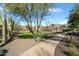 Lush community green space with mature trees, walking path, and well-maintained landscaping at 7340 E Conquistadores Dr, Scottsdale, AZ 85255