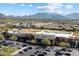 Overhead shot showcases a bustling shopping center set against a backdrop of mountains and desert landscapes at 7340 E Conquistadores Dr, Scottsdale, AZ 85255