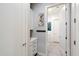 This hallway has white cabinets, storage and hooks for hanging items at 7340 E Conquistadores Dr, Scottsdale, AZ 85255