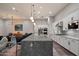 Spacious open kitchen with white cabinetry, granite countertops, and a seamless transition to the living area, perfect for entertaining at 7340 E Conquistadores Dr, Scottsdale, AZ 85255