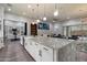 Open kitchen with a large center island, white cabinetry, and seamless connectivity to the adjacent living spaces at 7340 E Conquistadores Dr, Scottsdale, AZ 85255