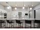 Contemporary kitchen features stainless steel appliances, granite countertops, and stylish pendant lighting over the central island at 7340 E Conquistadores Dr, Scottsdale, AZ 85255