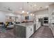 Open kitchen featuring a large island, stainless steel appliances, and seamless flow to the living area with a sliding glass door at 7340 E Conquistadores Dr, Scottsdale, AZ 85255