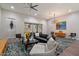 Bright living room with hardwood floors, comfortable seating, and sliding glass door access to outdoor space at 7340 E Conquistadores Dr, Scottsdale, AZ 85255