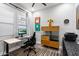 This office features a sit stand desk, rolling chair, decor, and plantation shutters at 7340 E Conquistadores Dr, Scottsdale, AZ 85255