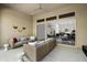 Inviting covered patio featuring wicker seating and view into an open-concept kitchen and living area at 7340 E Conquistadores Dr, Scottsdale, AZ 85255