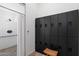 Clean shower with white tiled walls and floors, and a dark set of gym lockers at 7340 E Conquistadores Dr, Scottsdale, AZ 85255