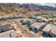 An aerial shot of a desert community shows modern homes with mountain views in background at 921 E Buist Ave, Phoenix, AZ 85042