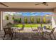 Charming covered patio that looks out to the lush green grass, perfect for entertaining guests in a serene setting at 921 E Buist Ave, Phoenix, AZ 85042