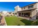 Spacious backyard featuring lush artificial turf, a tiled patio, and a seating area, perfect for outdoor entertaining at 921 E Buist Ave, Phoenix, AZ 85042