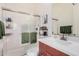 Modern bathroom with a glass-enclosed shower, sleek vanity, and contemporary fixtures at 921 E Buist Ave, Phoenix, AZ 85042