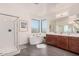 Bright bathroom with a soaking tub, walk-in shower, and double vanity at 921 E Buist Ave, Phoenix, AZ 85042