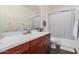 Clean bathroom features a vanity with storage, a large mirror, and a shower-tub combination at 921 E Buist Ave, Phoenix, AZ 85042