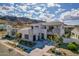 Two-story home boasts desert landscaping, three-car garage, concrete accents and mountain views at 921 E Buist Ave, Phoenix, AZ 85042