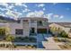 Stunning modern home with a stone facade, lush landscaping, and a spacious driveway, epitomizing luxurious curb appeal at 921 E Buist Ave, Phoenix, AZ 85042