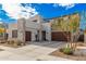 Modern two-story home featuring a three-car garage, desert landscaping, and concrete accents at 921 E Buist Ave, Phoenix, AZ 85042