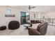 Bright, carpeted second-story living area features a leather sectional, a beanbag chair, and a sliding glass door to a balcony at 921 E Buist Ave, Phoenix, AZ 85042