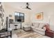 Inviting living room featuring a comfortable sectional sofa and workspace with scenic views and ample light at 921 E Buist Ave, Phoenix, AZ 85042
