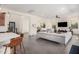 Bright open-concept living room with tile floors and a large gray sectional sofa at 921 E Buist Ave, Phoenix, AZ 85042
