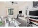 Open-concept living area featuring modern decor, comfortable seating, and a functional workspace at 921 E Buist Ave, Phoenix, AZ 85042