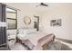 Relaxing main bedroom showcasing a comfortable bed, elegant decor, and large windows for natural light at 921 E Buist Ave, Phoenix, AZ 85042