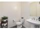 Stylish powder room with a pedestal sink and neutral decor at 921 E Buist Ave, Phoenix, AZ 85042