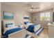 Cozy bedroom featuring two beds, soft carpeting, and warm lighting at 926 W Grand Caymen Dr, Gilbert, AZ 85233