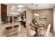 Bright dining room with seating for four and a view into the kitchen and its granite countertops at 926 W Grand Caymen Dr, Gilbert, AZ 85233