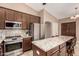 Modern kitchen featuring stainless steel appliances, granite countertops, and a center island at 926 W Grand Caymen Dr, Gilbert, AZ 85233