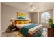 Comfortable main bedroom with ample natural light, ceiling fan, and a decorative rug at 926 W Grand Caymen Dr, Gilbert, AZ 85233
