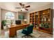 Bright office space with a built-in bookshelf, desk, and natural light from a large window at 926 W Grand Caymen Dr, Gilbert, AZ 85233