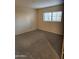 Neutral bedroom featuring a light tan carpet and a window with blinds at 10080 E Mountainview Lake Dr # 110, Scottsdale, AZ 85258