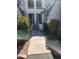 Inviting condo exterior with well maintained walkway, beautiful flowering bushes, and covered entrances at 10080 E Mountainview Lake Dr # 110, Scottsdale, AZ 85258