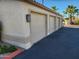 Garage featuring a three car configuration and desert landscaping at 10080 E Mountainview Lake Dr # 110, Scottsdale, AZ 85258