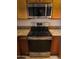 Close-up of the black stainless steel stove and microwave in the kitchen with granite counters at 10080 E Mountainview Lake Dr # 110, Scottsdale, AZ 85258