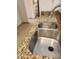 Well-maintained kitchen with a stainless steel sink and attractive granite countertops at 10080 E Mountainview Lake Dr # 110, Scottsdale, AZ 85258