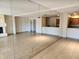 Open concept living room featuring tiled flooring, kitchen, and mirrored wall at 10080 E Mountainview Lake Dr # 110, Scottsdale, AZ 85258