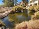 Beautiful view of the lush pond and surrounding landscaping provides a calming community view at 10080 E Mountainview Lake Dr # 110, Scottsdale, AZ 85258