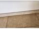 Close up shot of a neutral tile floor with baseboard trim at 10080 E Mountainview Lake Dr # 110, Scottsdale, AZ 85258