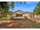 Rear view of house featuring backyard with pool, palm trees and lush lawn at 1079 S Western Skies Dr, Gilbert, AZ 85296