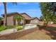Back of house with backyard, pool, palm trees, and a block fence at 1079 S Western Skies Dr, Gilbert, AZ 85296